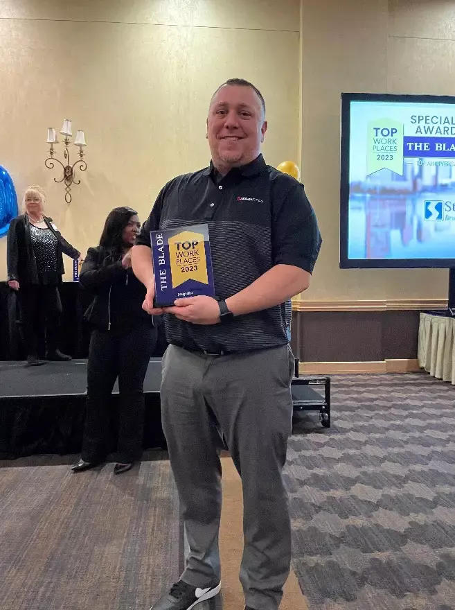 Mark Moll, Senior Project Manager, accepted the 2023 Top Workplace and Superior New Ideas awards on behalf of Designetics